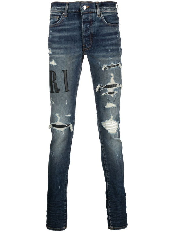 AMIRI distressed logo-print skinny jeans
